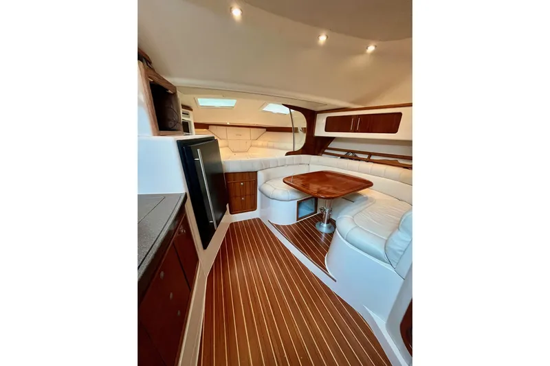  Yacht Photos Pics Luxurious interior of 2005 Grady-White Express 360 with wood flooring and plush seating.