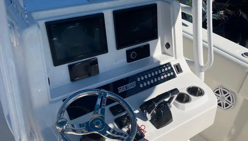  Yacht Photos Pics Cockpit of 2019 Sea Tech 33 boat with steering wheel and control panel.