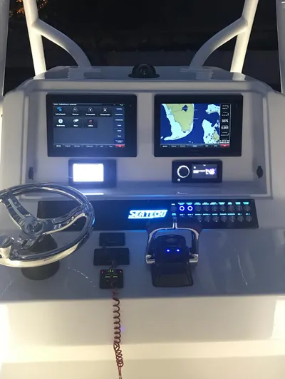  Yacht Photos Pics 2019 Sea Tech 33 boat dashboard with navigation screens and controls.