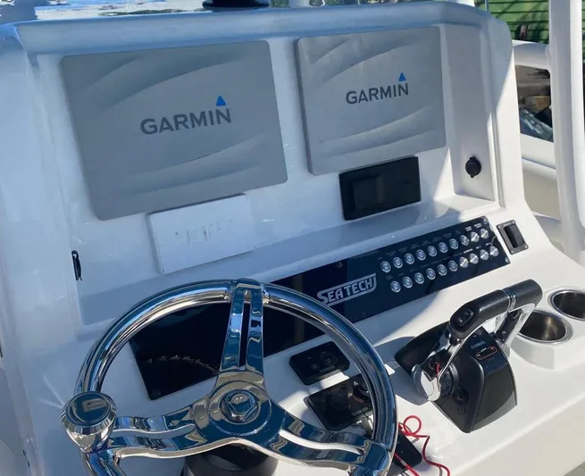  Yacht Photos Pics 2019 Sea Tech 33 boat dashboard with Garmin displays and steering wheel.
