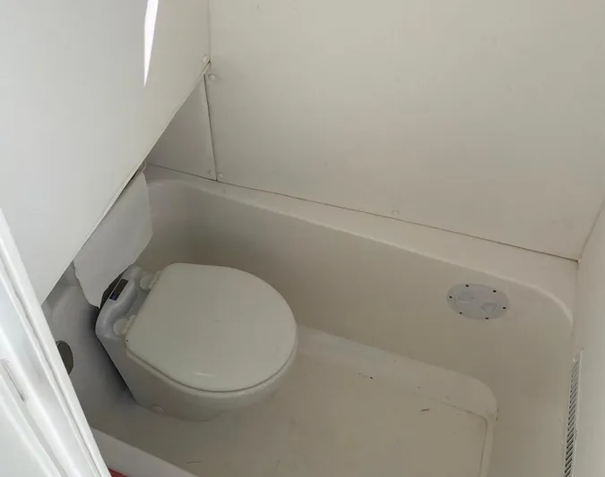 Yacht Photos Pics Compact marine toilet in a 2019 Sea Tech 33 boat bathroom.