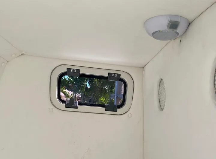  Yacht Photos Pics Interior of a 2019 Sea Tech 33 boat cabin with window and ceiling light.