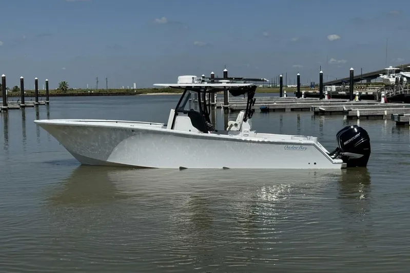  Yacht Photos Pics 2022 Onslow Bay 33 TE boat in calm marina waters, side view.