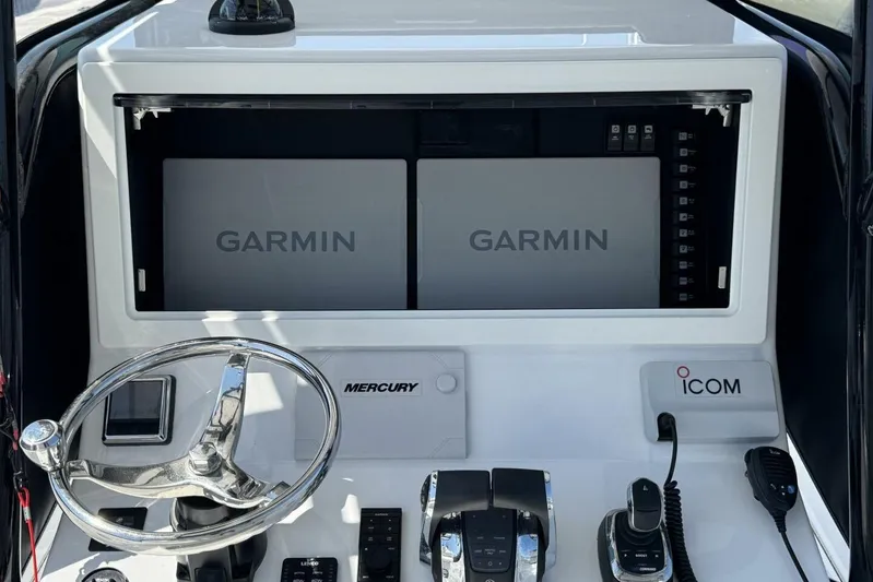  Yacht Photos Pics 2022 Onslow Bay 33 TE boat dashboard with Garmin displays and Mercury controls.