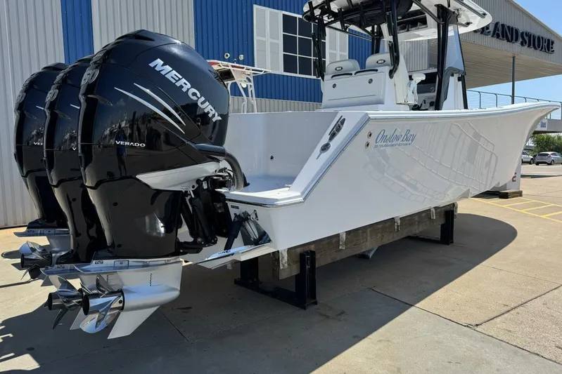  Yacht Photos Pics 2022 Onslow Bay 33 TE boat with triple Mercury Verado engines, docked at a marina.