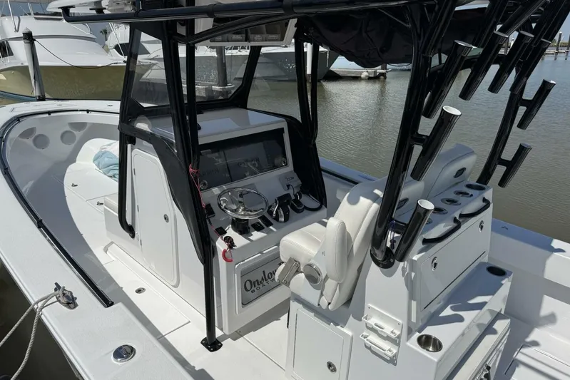  Yacht Photos Pics 2022 Onslow Bay 33 TE boat interior with helm and seating, docked at marina.