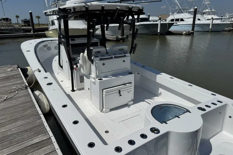  Yacht Photos Pics 2022 Onslow Bay 33 TE boat docked, showcasing spacious deck and seating area.