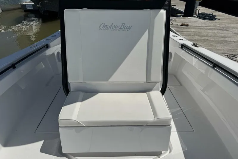  Yacht Photos Pics 2022 Onslow Bay 33 TE boat seat, white upholstery, docked by the water.