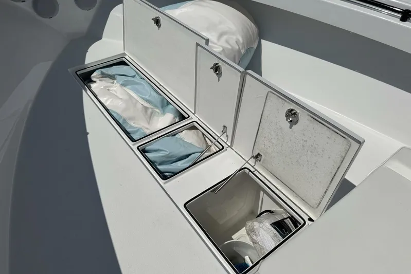  Yacht Photos Pics Storage compartments on a 2022 Onslow Bay 33 TE boat, containing various items.