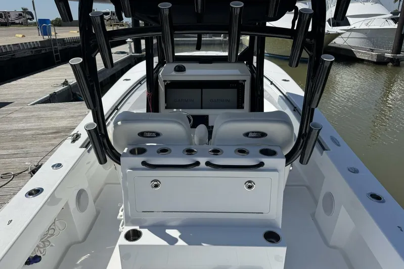  Yacht Photos Pics 2022 Onslow Bay 33 TE boat interior with Garmin displays and rod holders at dock.