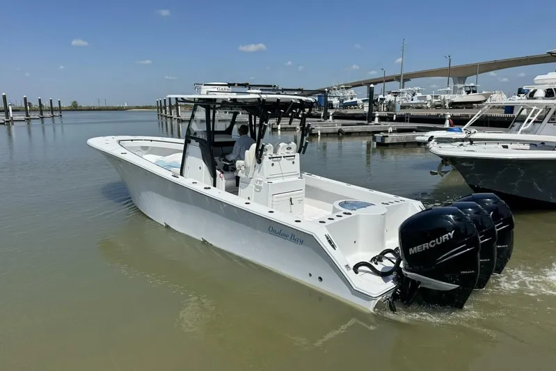  Yacht Photos Pics 2022 Onslow Bay 33 TE boat with triple Mercury engines docked in marina.