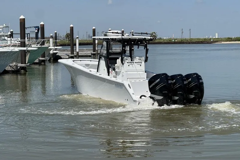  Yacht Photos Pics 2022 Onslow Bay 33 TE boat with triple Mercury engines in a marina setting.