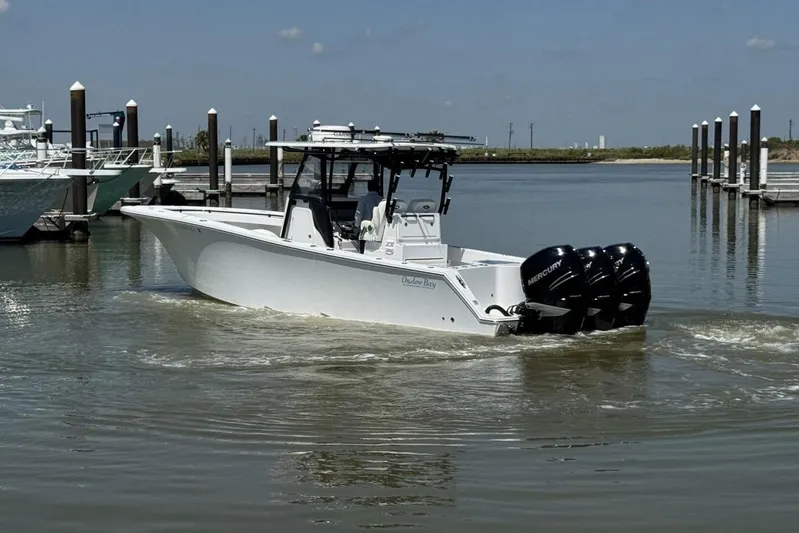  Yacht Photos Pics 2022 Onslow Bay 33 TE boat with triple Mercury engines in a marina setting.