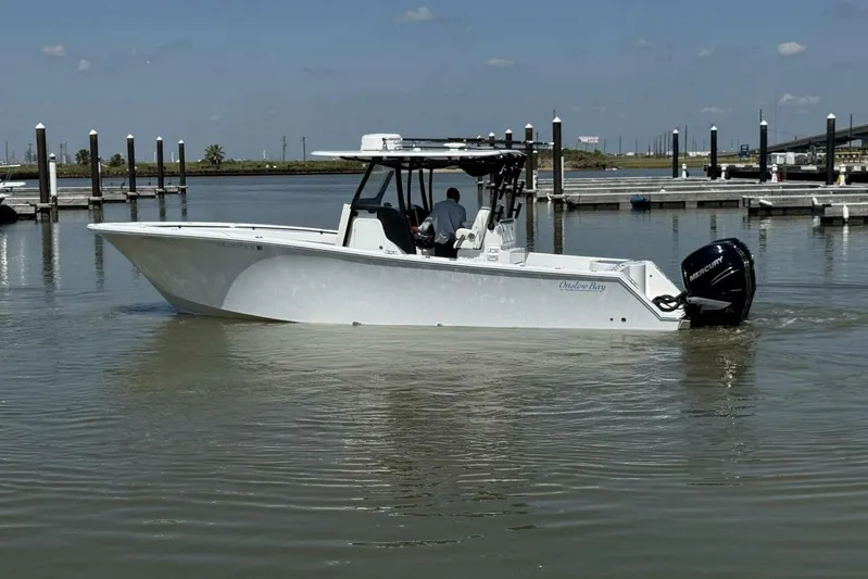  Yacht Photos Pics 2022 Onslow Bay 33 TE boat in marina, featuring sleek design and powerful Mercury engine.