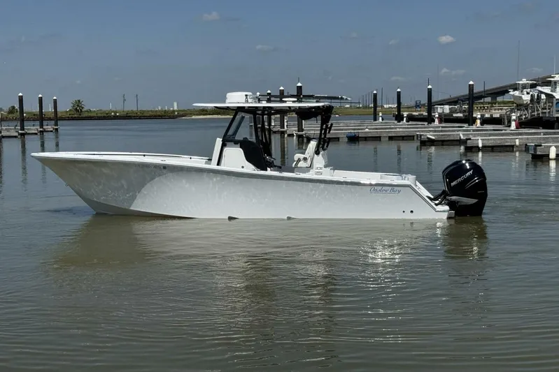  Yacht Photos Pics 2022 Onslow Bay 33 TE boat docked in calm waters under a clear sky.