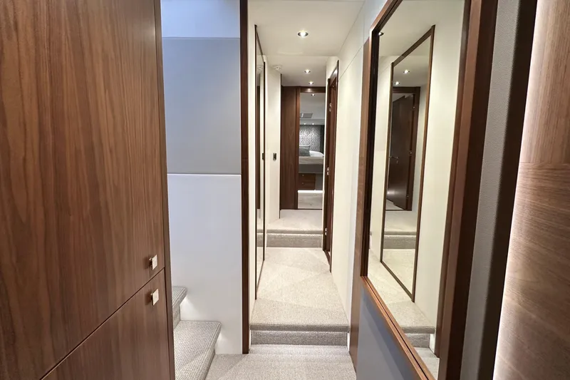 Enough Yacht Photos Pics Luxurious interior hallway of 2023 Sunseeker 76 Yacht with wood paneling and modern design.