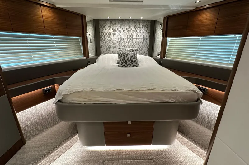 Enough Yacht Photos Pics Luxurious bedroom interior of 2023 Sunseeker 76 Yacht with modern design and ambient lighting.