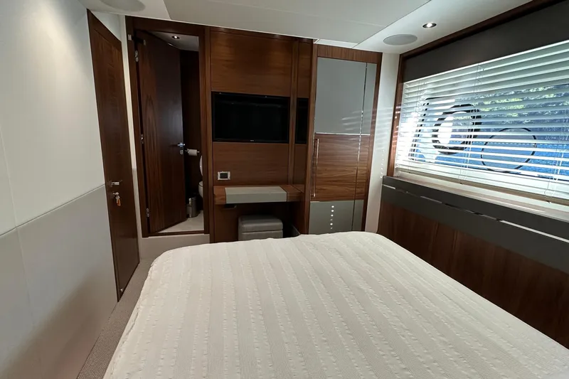 Enough Yacht Photos Pics Luxurious cabin interior of 2023 Sunseeker 76 Yacht with modern wood finishes.