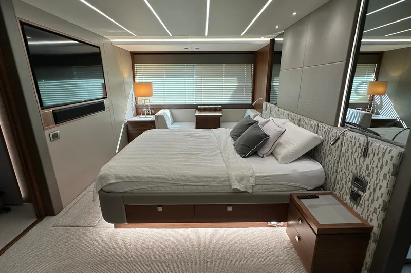 Enough Yacht Photos Pics Luxurious bedroom interior of 2023 Sunseeker 76 Yacht with modern design and elegant furnishings.