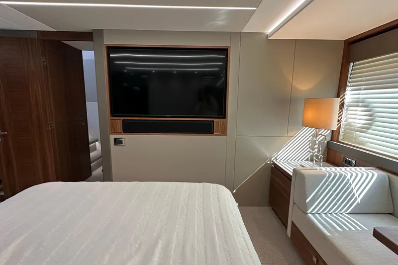 Enough Yacht Photos Pics Luxurious interior of 2023 Sunseeker 76 Yacht with modern decor and large TV.