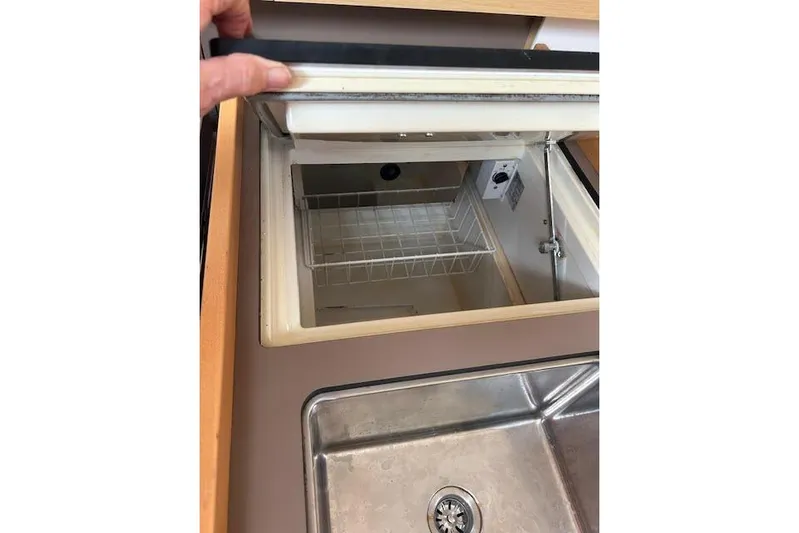 Hummingbird Yacht Photos Pics Interior view of a 2017 Beneteau Oceanis 38.1 yacht kitchen sink and storage.