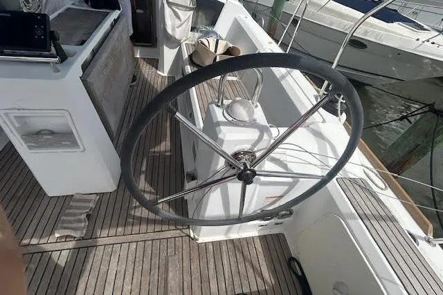 Hummingbird Yacht Photos Pics 2017 Beneteau Oceanis 38.1 sailboat cockpit with steering wheel and wooden deck.