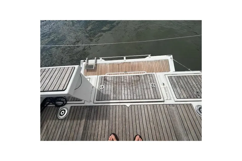 Hummingbird Yacht Photos Pics 2017 Beneteau Oceanis 38.1 yacht deck with wooden finish, overlooking water.