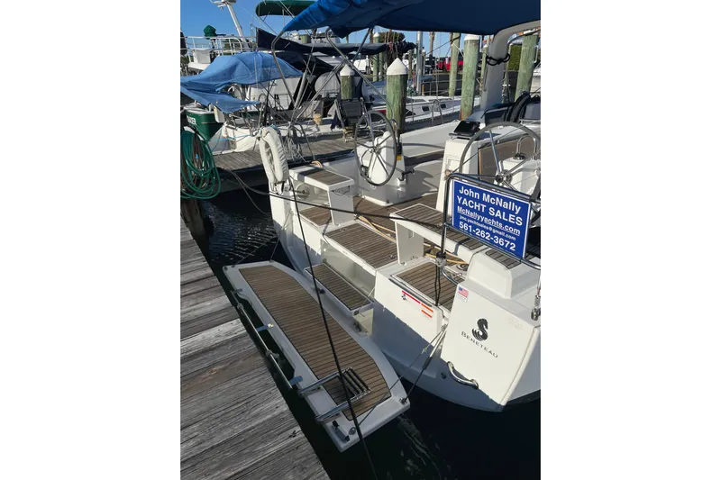 Hummingbird Yacht Photos Pics 2017 Beneteau Oceanis 38.1 yacht docked, featuring a spacious deck and sales sign.