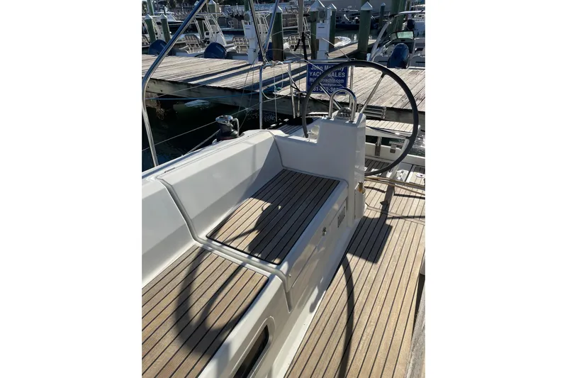 Hummingbird Yacht Photos Pics 2017 Beneteau Oceanis 38.1 yacht cockpit with wooden deck and steering wheel.