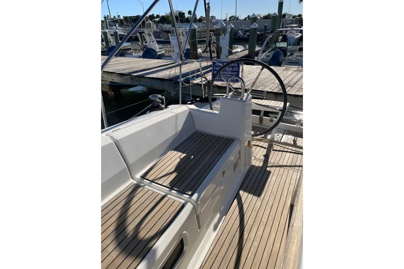 Hummingbird Yacht Photos Pics 2017 Beneteau Oceanis 38.1 yacht cockpit with wooden deck and steering wheel.