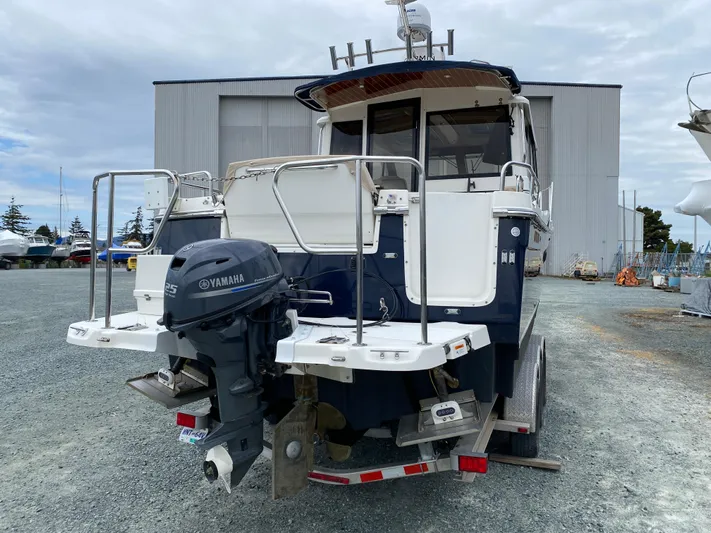  Yacht Photos Pics 2017 Cutwater C-28 boat with Yamaha outboard motor on trailer, parked near a large building.