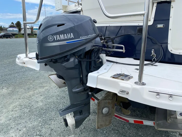  Yacht Photos Pics 2017 Cutwater C-28 boat with Yamaha outboard motor on a gravel surface.