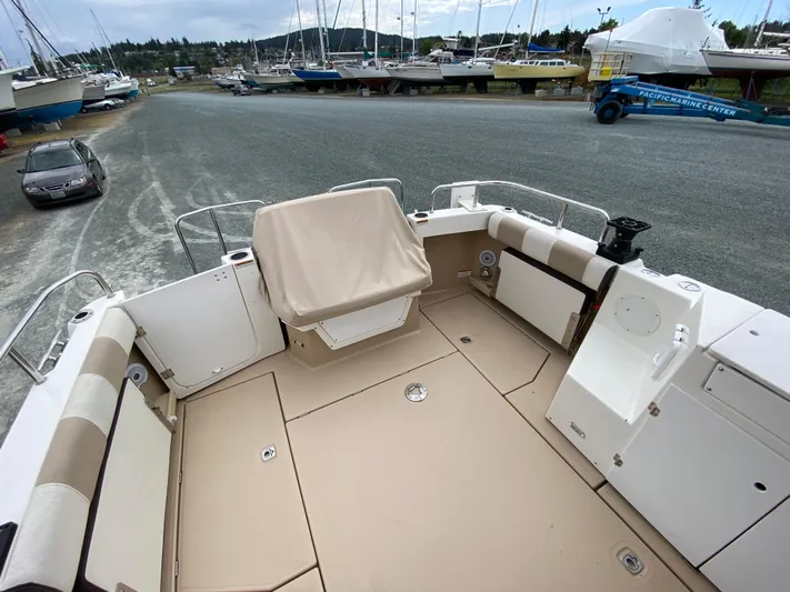  Yacht Photos Pics 2017 Cutwater C-28 boat deck with seating, docked near other boats.