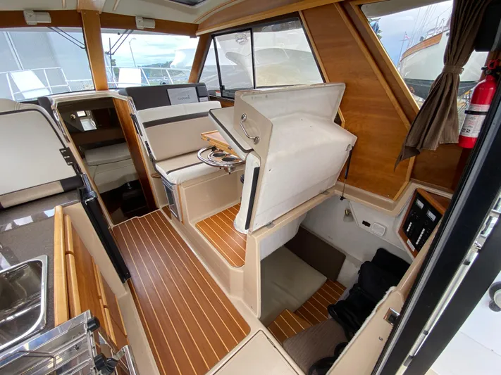  Yacht Photos Pics Interior of a 2017 Cutwater C-28 boat with wood accents and seating area.
