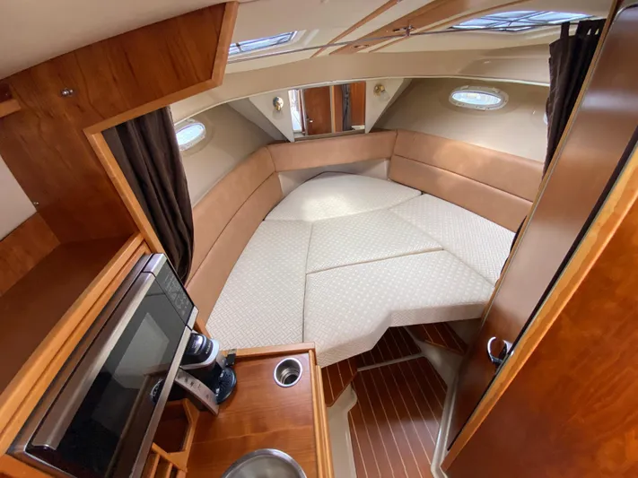  Yacht Photos Pics 2017 Cutwater C-28 cabin interior with cozy seating and kitchenette.