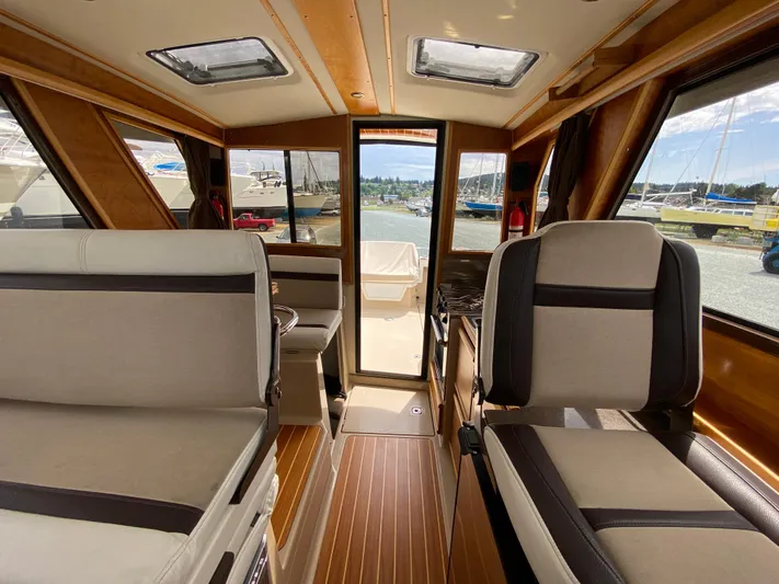  Yacht Photos Pics Interior of 2017 Cutwater C-28 boat with seating and wood accents.