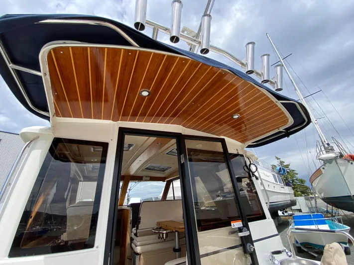  Yacht Photos Pics 2017 Cutwater C-28 boat with wooden ceiling and sleek design, docked under cloudy skies.