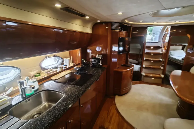  Yacht Photos Pics Luxurious interior of 2009 Princess V58 yacht with modern kitchen and cozy living area.