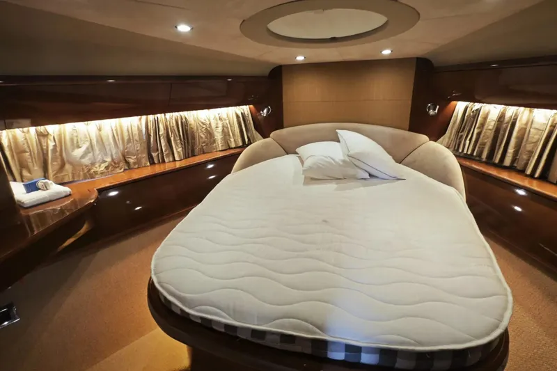  Yacht Photos Pics Luxurious cabin interior of 2009 Princess V58 yacht with elegant bedding and ambient lighting.