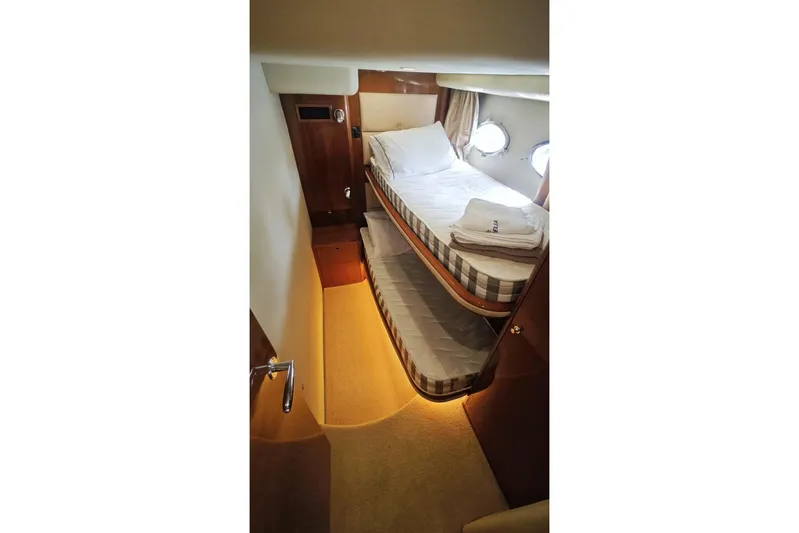 Yacht Photos Pics 2009 Princess V58 yacht cabin with bunk beds and porthole windows.