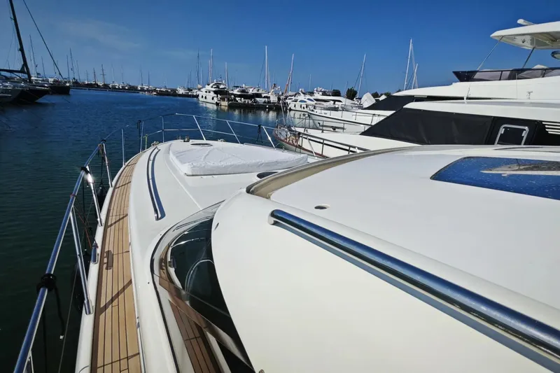  Yacht Photos Pics 2009 Princess V58 yacht docked in a marina, surrounded by other luxury boats.