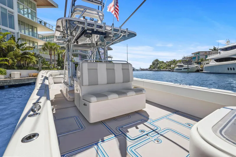  Yacht Photos Pics 2013 Invincible 42 Open Fisherman boat docked by waterfront homes.