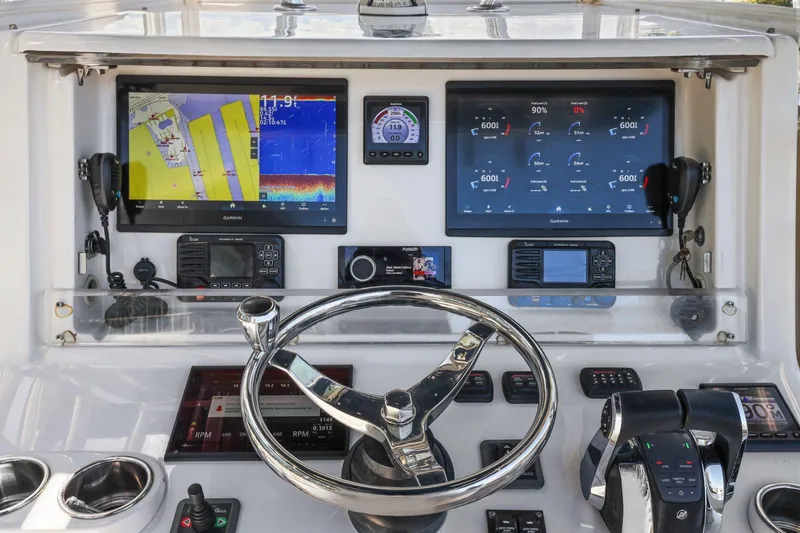  Yacht Photos Pics Helm of 2013 Invincible 42 Open Fisherman with advanced navigation displays and controls.