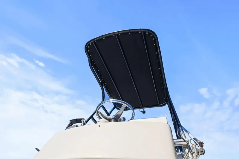  Yacht Photos Pics 2013 Invincible 42 Open Fisherman boat helm with T-top against blue sky.