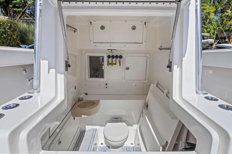  Yacht Photos Pics Interior of 2013 Invincible 42 Open Fisherman boat, featuring a compact bathroom area.