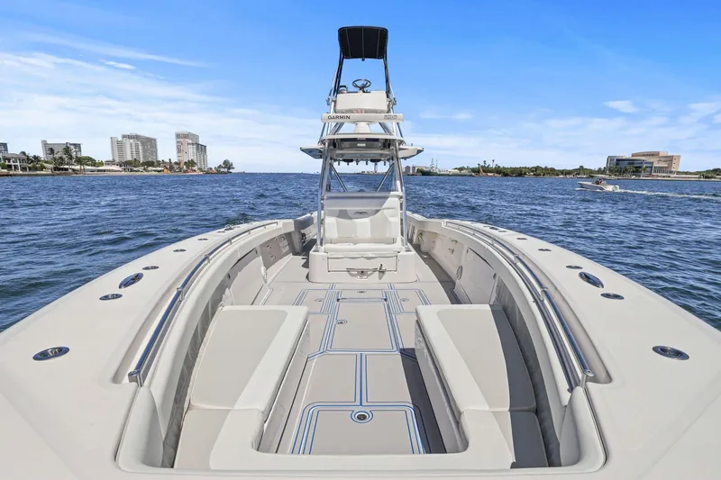  Yacht Photos Pics 2013 Invincible 42 Open Fisherman boat on water, city skyline in background.