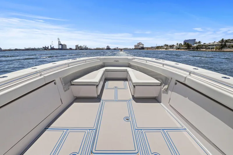  Yacht Photos Pics 2013 Invincible 42 Open Fisherman boat on water, spacious deck, clear sky.