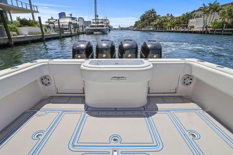  Yacht Photos Pics 2013 Invincible 42 Open Fisherman boat with four engines, docked in a scenic marina.