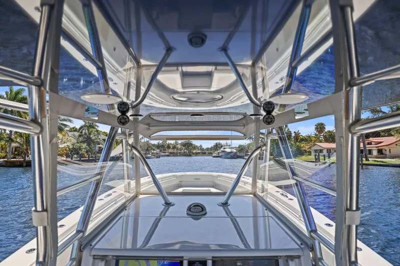  Yacht Photos Pics 2013 Invincible 42 Open Fisherman boat interior with clear view of waterway and palm trees.