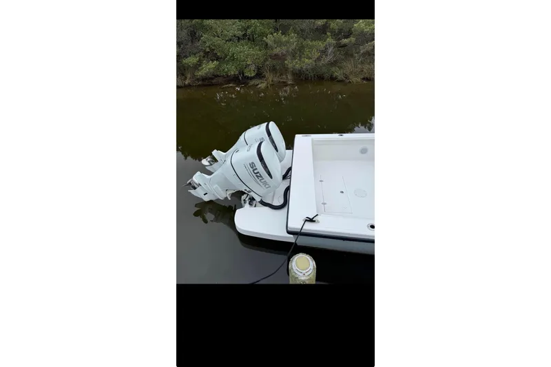  Yacht Photos Pics Ocean Master 27 boat with Suzuki outboard motor, docked in calm waters, 2021 model.